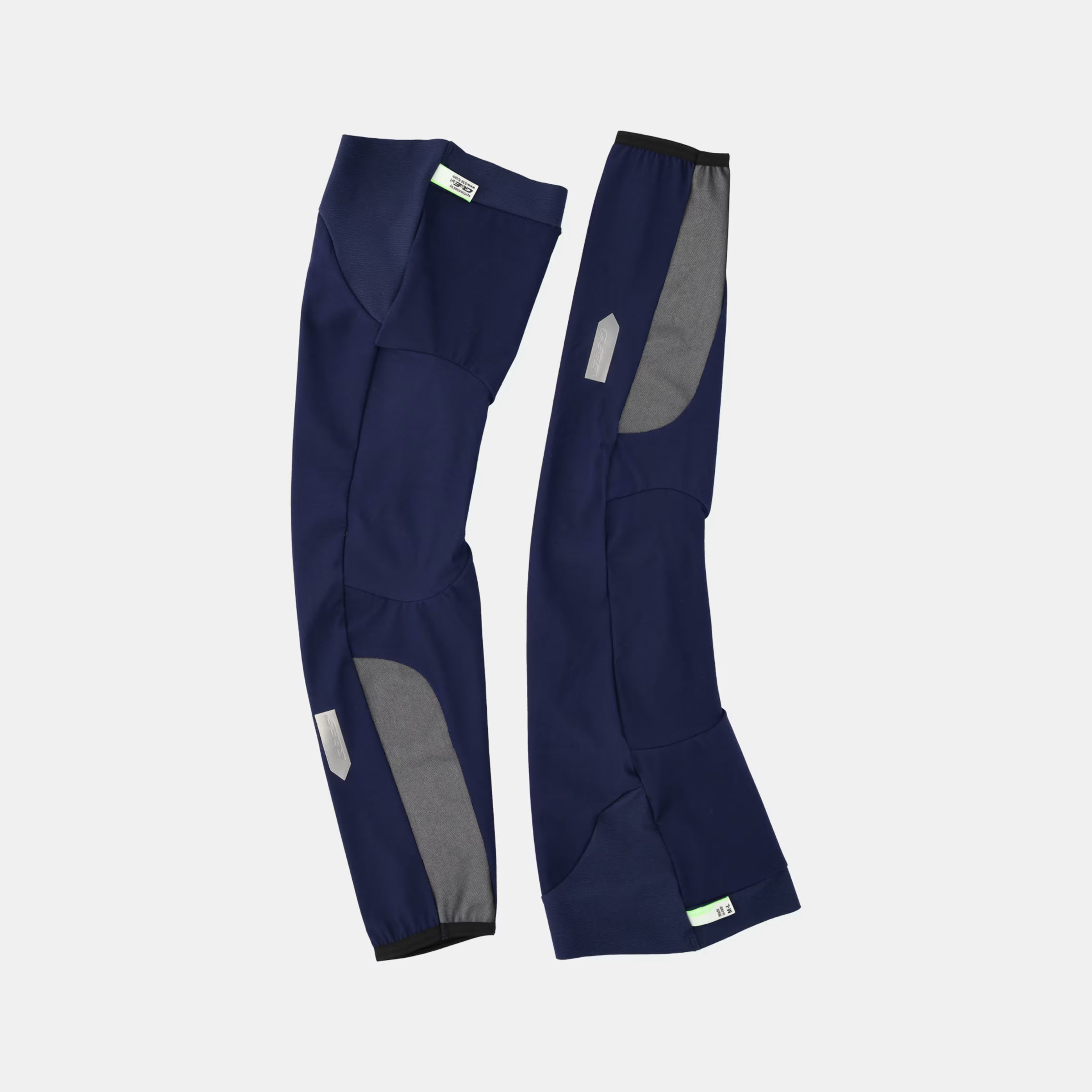 Pair of Q36.5 WoolF Leg Warmer - Navy Blue showing dual-layer woven merino blend fabric with reflective details
