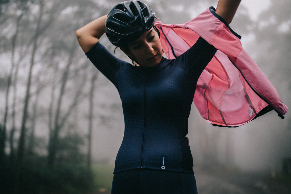 women wearing black sheep cycling TEAM essential jersey in navy and the TEAM vest in pink, roadkit