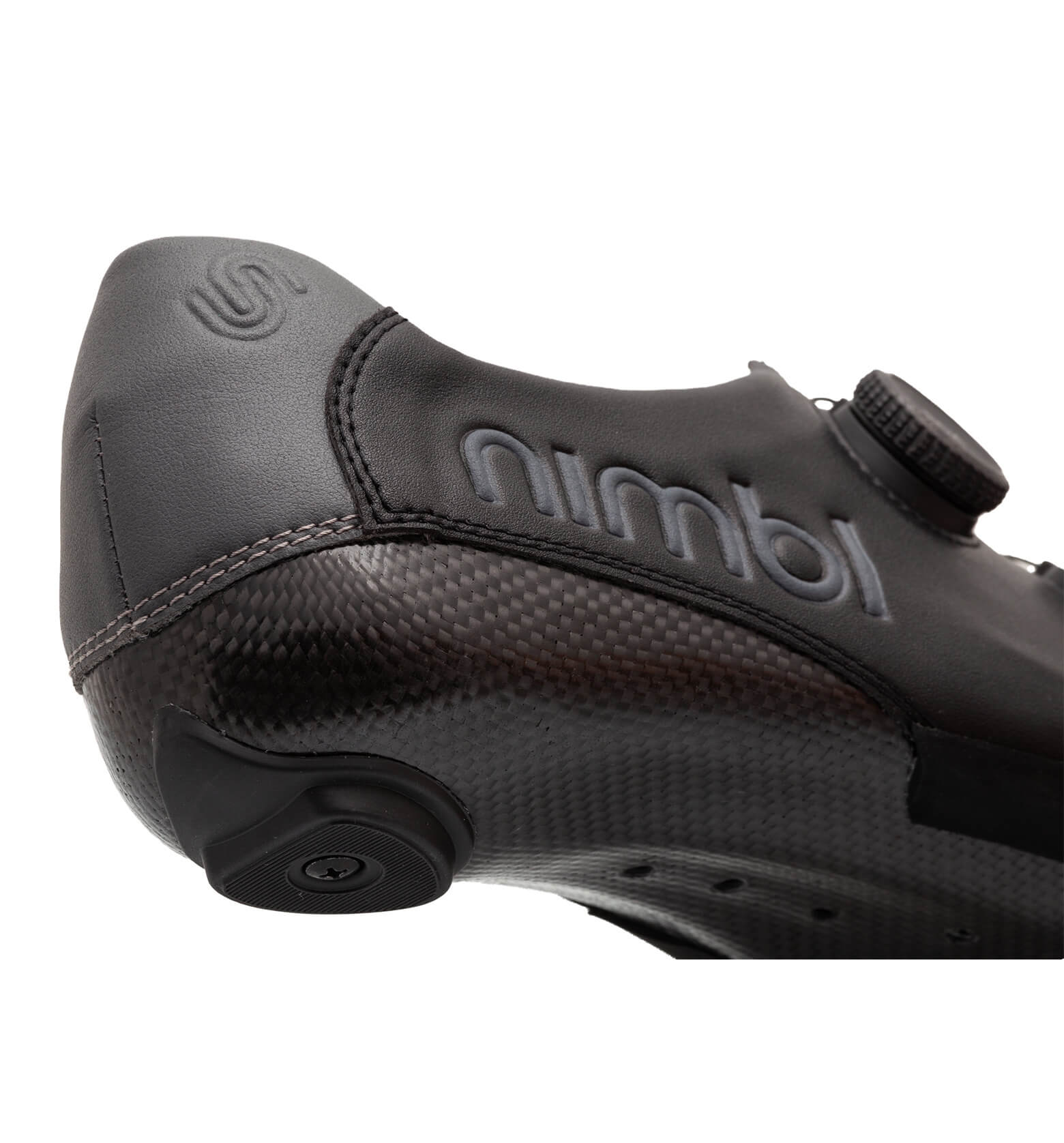 Close-up of the Nimbl EXCEED cycling shoe showing carbon sole, black upper, and branded side detail with adjustment dial