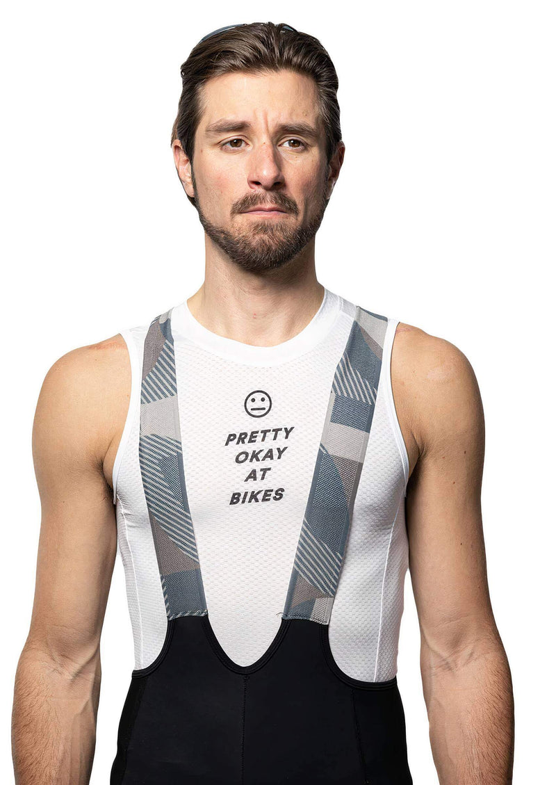 A man in the Ostroy "Pretty Okay at Bikes" sleeveless base layer with a gray pattern.