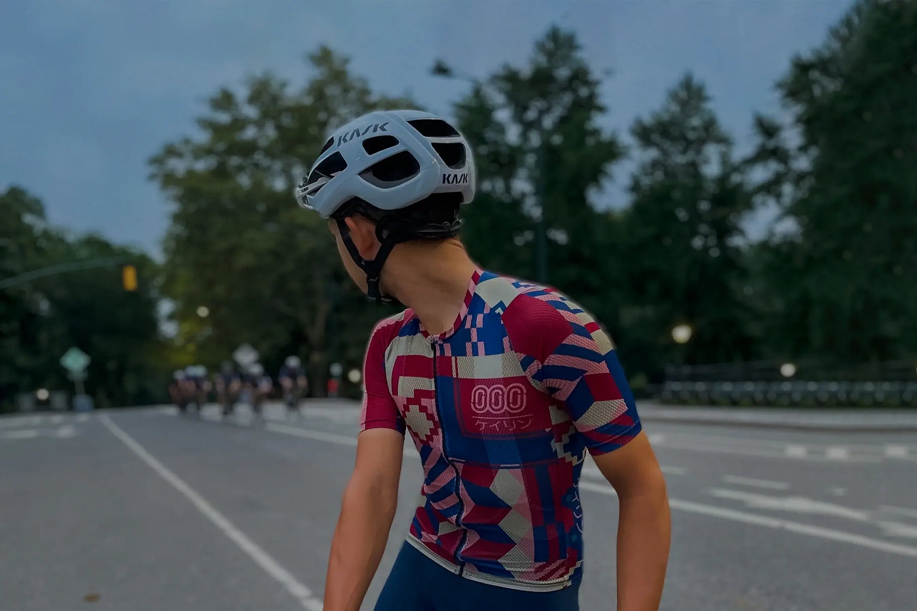 Male cyclist wearing the red Keirin mesh jersey from Ostroy and the Ostroy Nomad team bib in blue