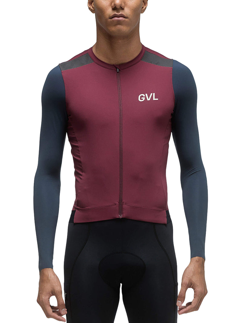 A full front view of a male model wearing the Givelo Modern Classic long sleeve jersey in burgundy with grey and navy panels, zipped up and fitted, showing the torso and sleeve details.