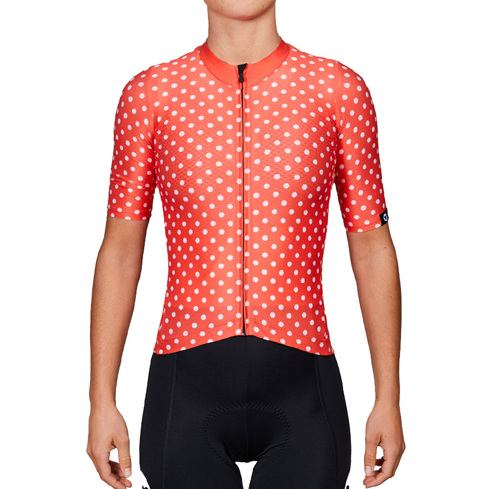 Front view of Black Sheep Cycling Women's TC19 Dot Jersey - Warm Red with white dots and short sleeves worn by a model