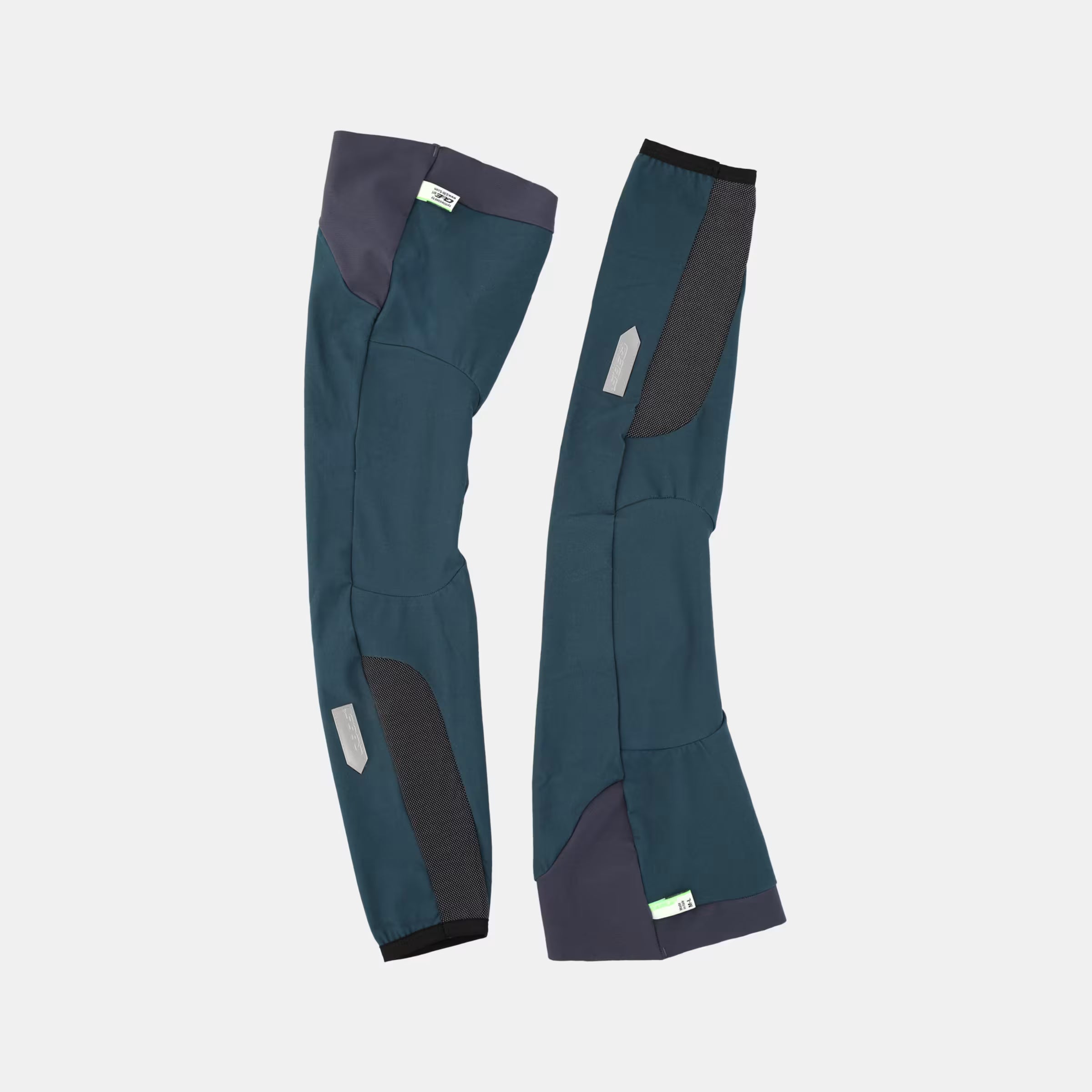 Q36.5 WoolF Leg Warmer - Australian Green pair showing dual-layer fabric and reflective logo detail on light background