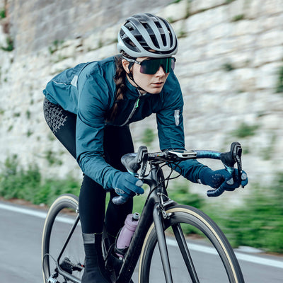 Female cyclist in action wearing Q36.5 Grid Skin Winter Bib Tights for warmth and protection.