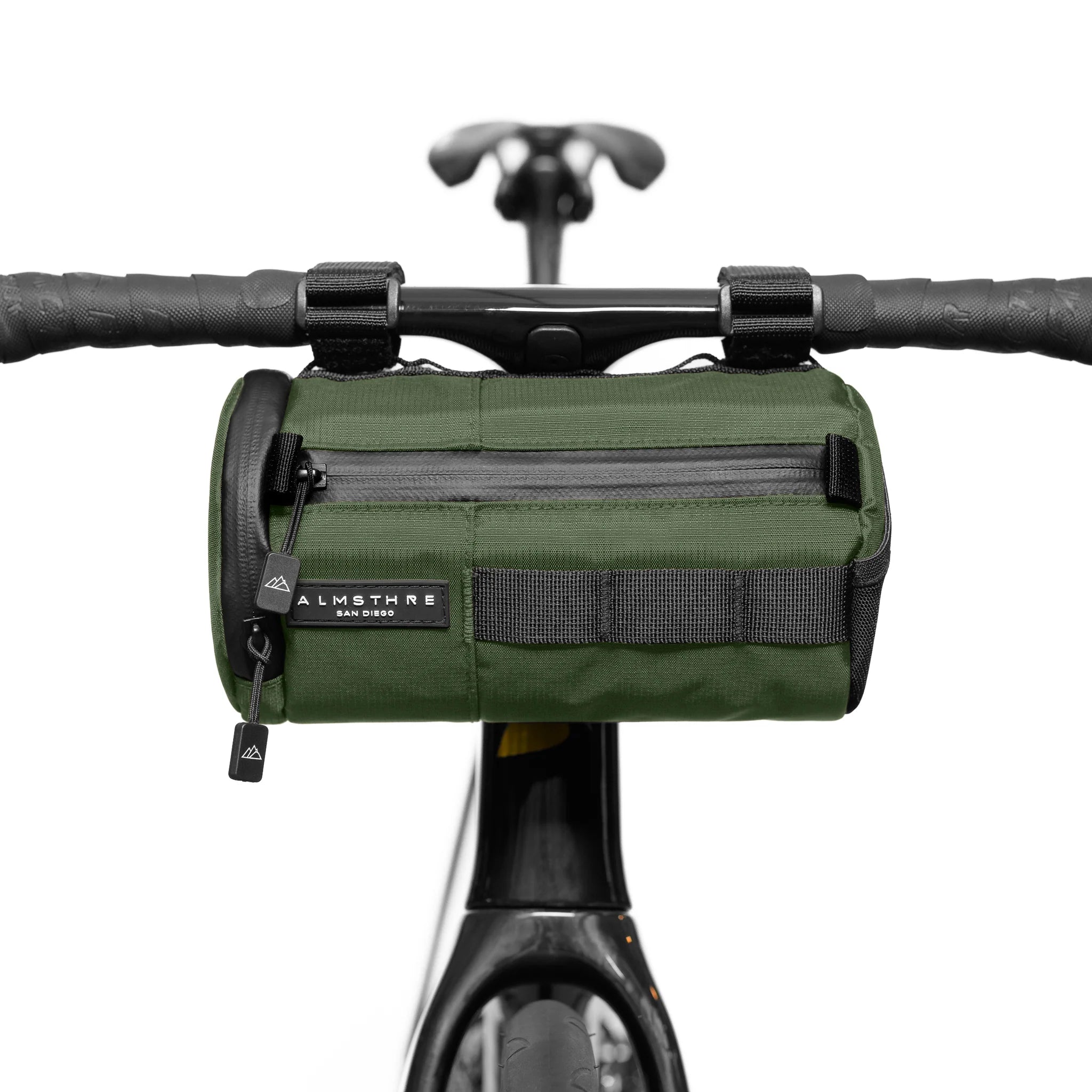 ALMSTHRE Signature Bar Bag in green mounted on bike handlebar with front zipper and durable attachment straps