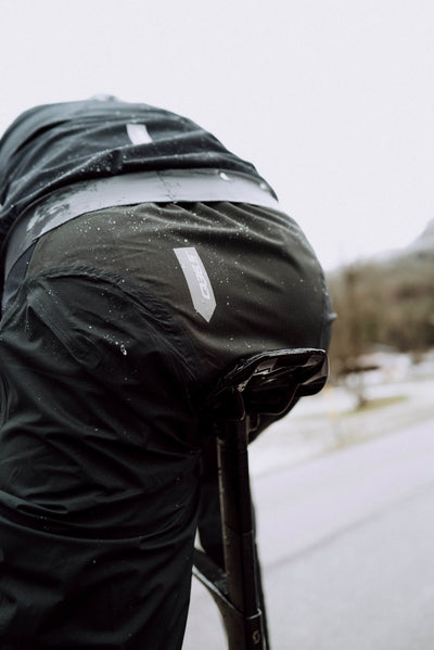 Close-up of Q36.5 Rain Overpants' back showing taped seams and abrasion-resistant area.