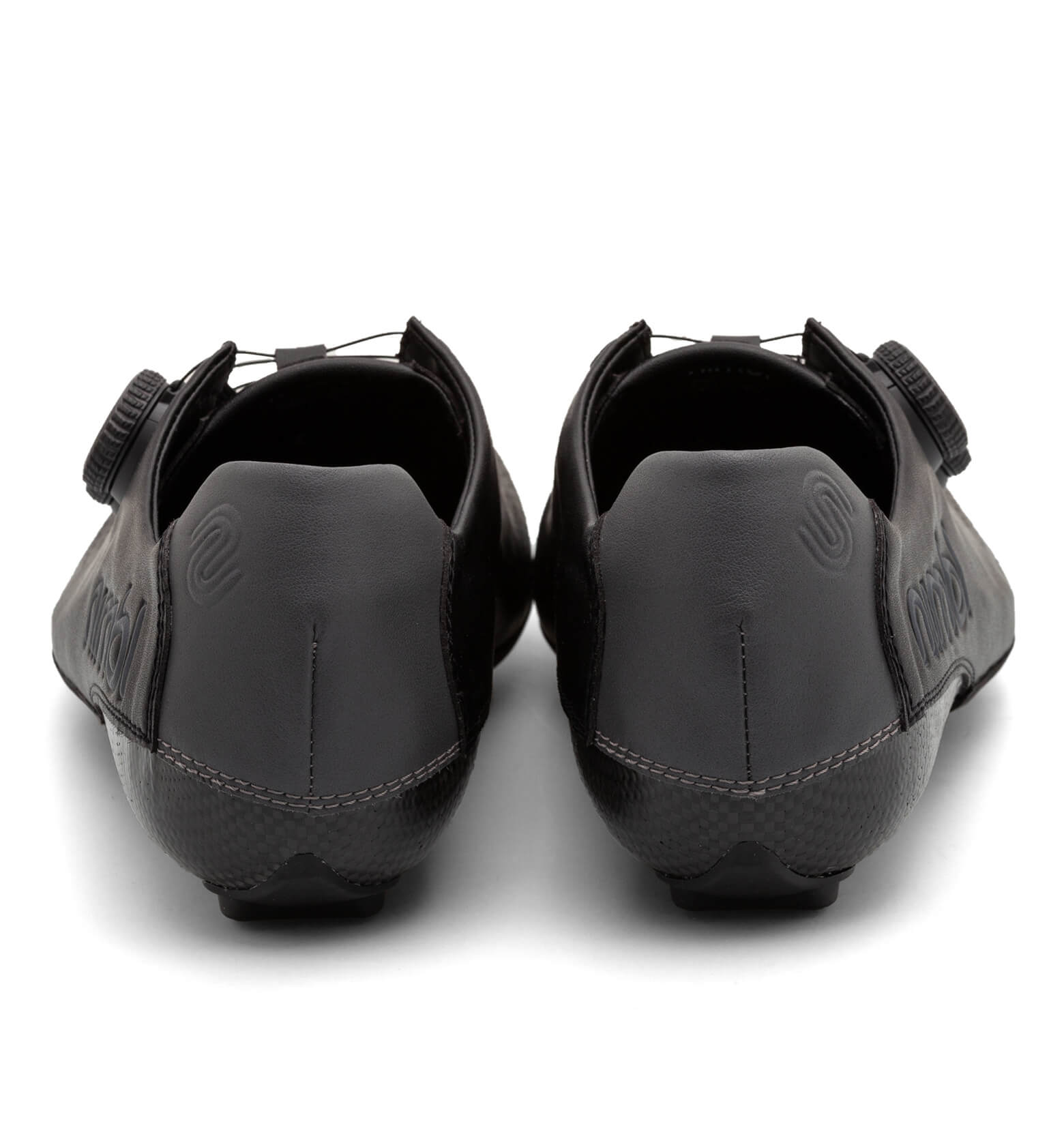 Pair of black Nimbl EXCEED cycling shoes shown from the rear with dial closure system and sleek heel design