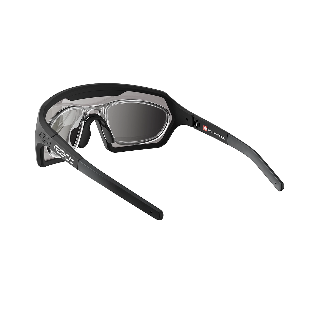 REACT Correction Clip for Rev shown attached to black frame sunglasses with clear and tinted lenses against white background