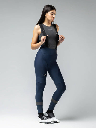 A pair of navy blue women's long cycling bib tights with black shoulder straps. 