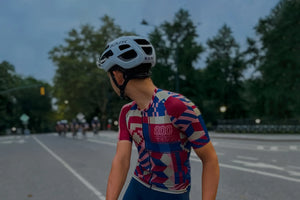 Male cyclist wearing the red Keirin mesh jersey from Ostroy and the Ostroy Nomad team bib in blue