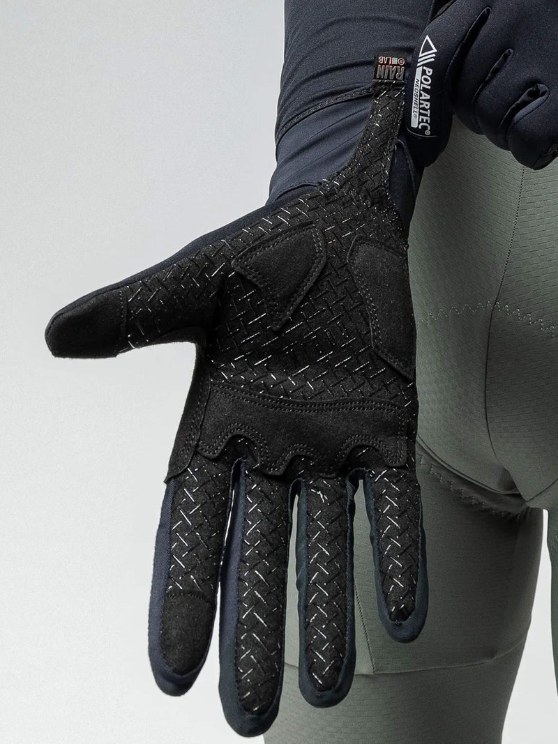A man wearing a black cycling jacket and gloves, ready for winter cycling with NEOSHELL BORA Unisex Thermal Gloves.