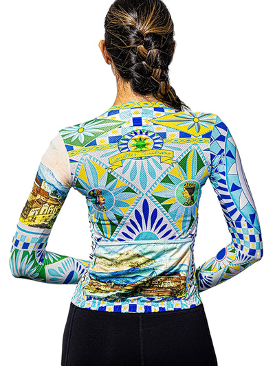Full body view of a woman wearing the Ostroy Carretto jersey, with a background highlighting the jersey's design that echoes art from around the world.