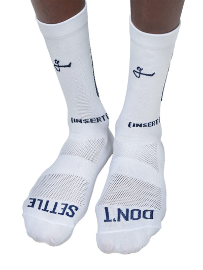 Image showing the front view of white Givelo G-Socks with the Chaos design, featuring a bold black angular pattern and the word "Chaos" along the side. The design indicates a blend of style and function.