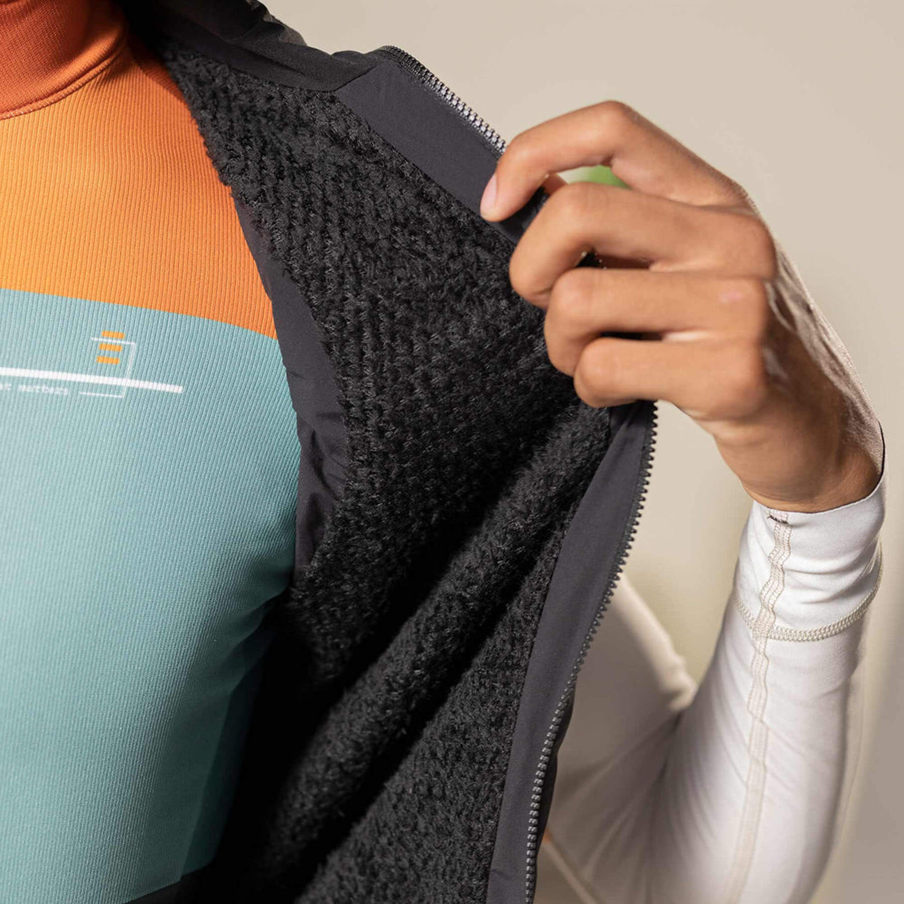 Close-up of Eminent black gilet interior, showcasing the Polartec® Alpha® insulation for warmth.