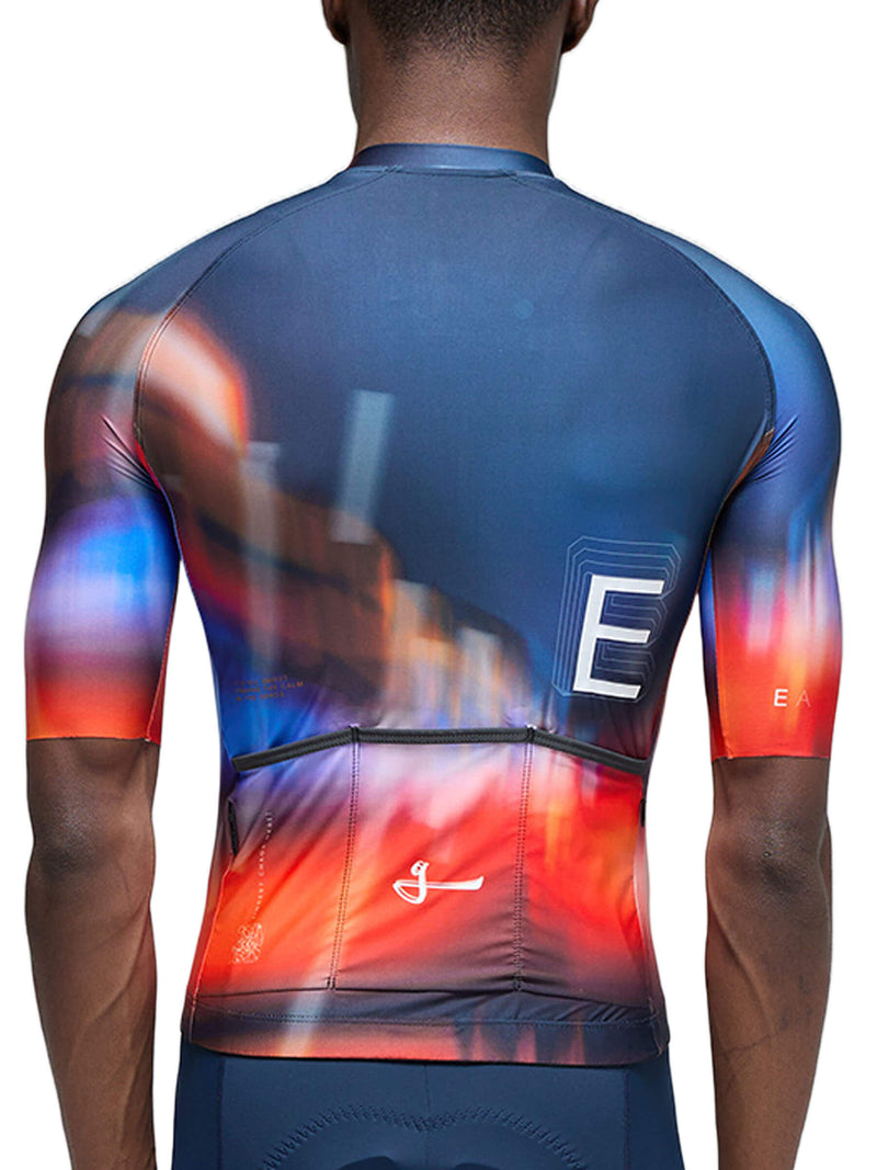 Rear view of a cyclist in the Givelo Essentials Chaos jersey showing the back pockets and gradient design.