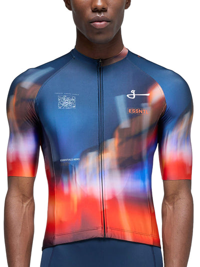 Front view of a cyclist wearing the Givelo Essentials Chaos jersey with a red to blue gradient.