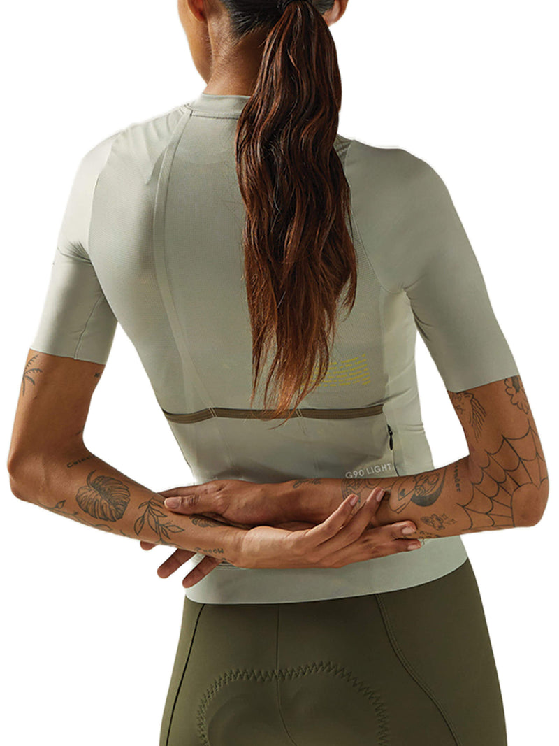 Female cyclist showing the back of a Givelo G90 Light jersey in mint with secure pocket design.