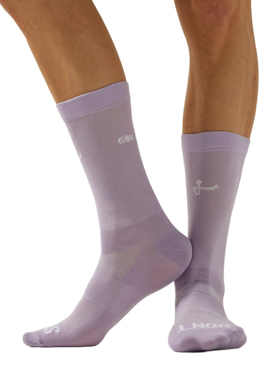 Image of light mauve Givelo G-Socks, showing the side view of a pair of feet. The socks feature a snug fit with breathable mesh sections and reinforced toe and heel areas. The Givelo logo is visible on the cuff and across the toes.
