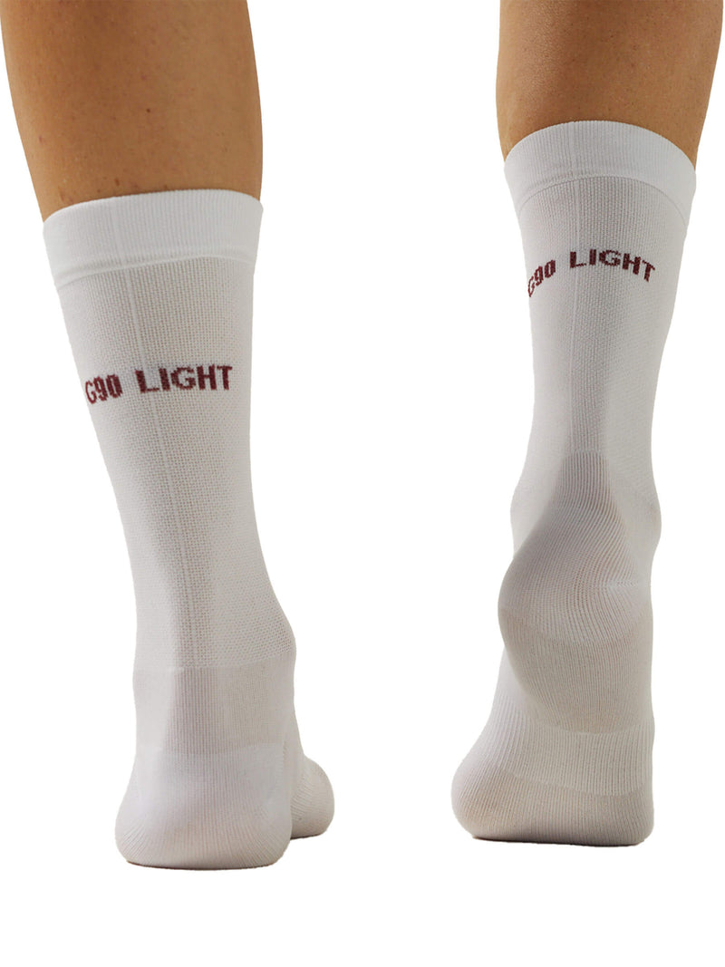 Image depicting the back view of the Givelo G-Socks in white with red accents. This view focuses on the elastic support band around the ankle and the ribbed texture extending up the calf.