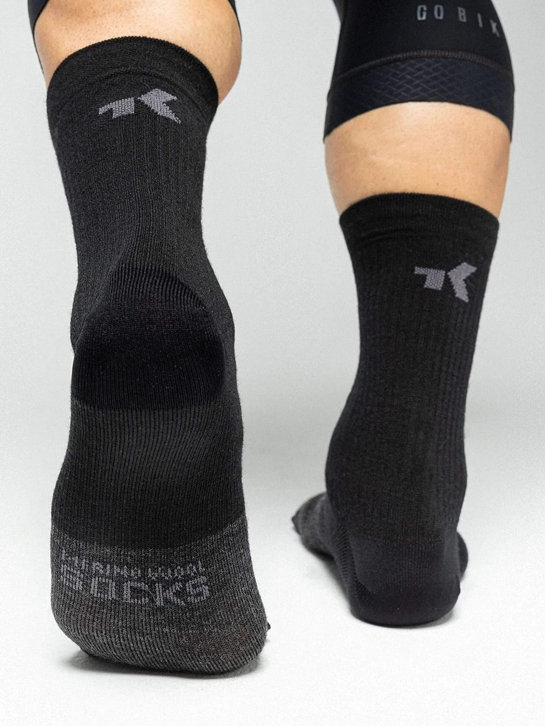 Pair of black GOBIK Winter Merino Socks made of natural fibers for warmth and temperature regulation in cold weather.