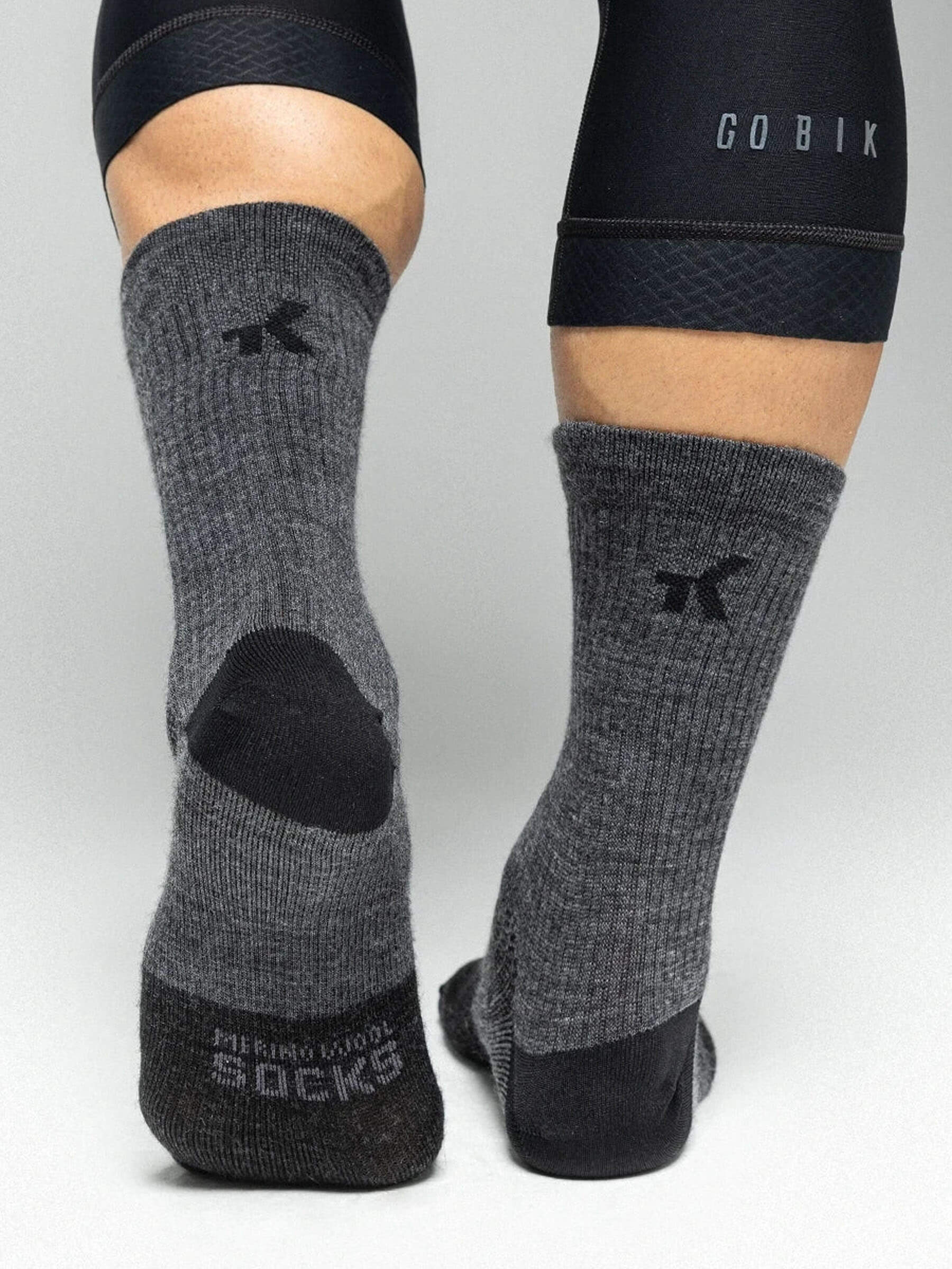 Pair of dark gray GOBIK Winter Merino Socks made from soft, natural fibers for warmth and comfort in cold weather.