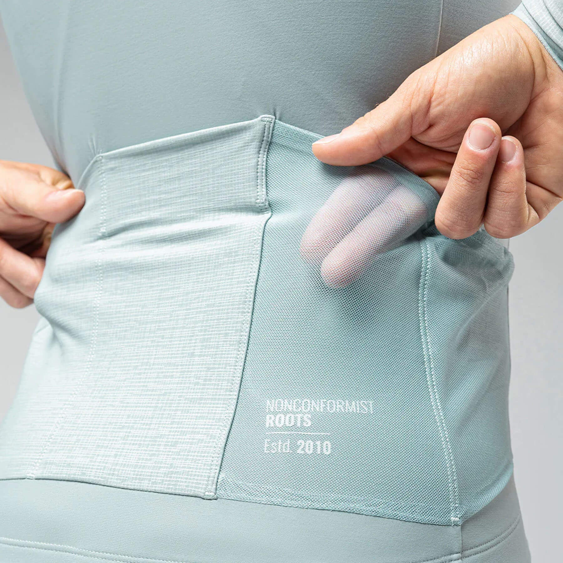 Close-up of the breathable back pocket detail on the GOBIK Pacer Solid Long Sleeve Jersey - Men's cycling top.