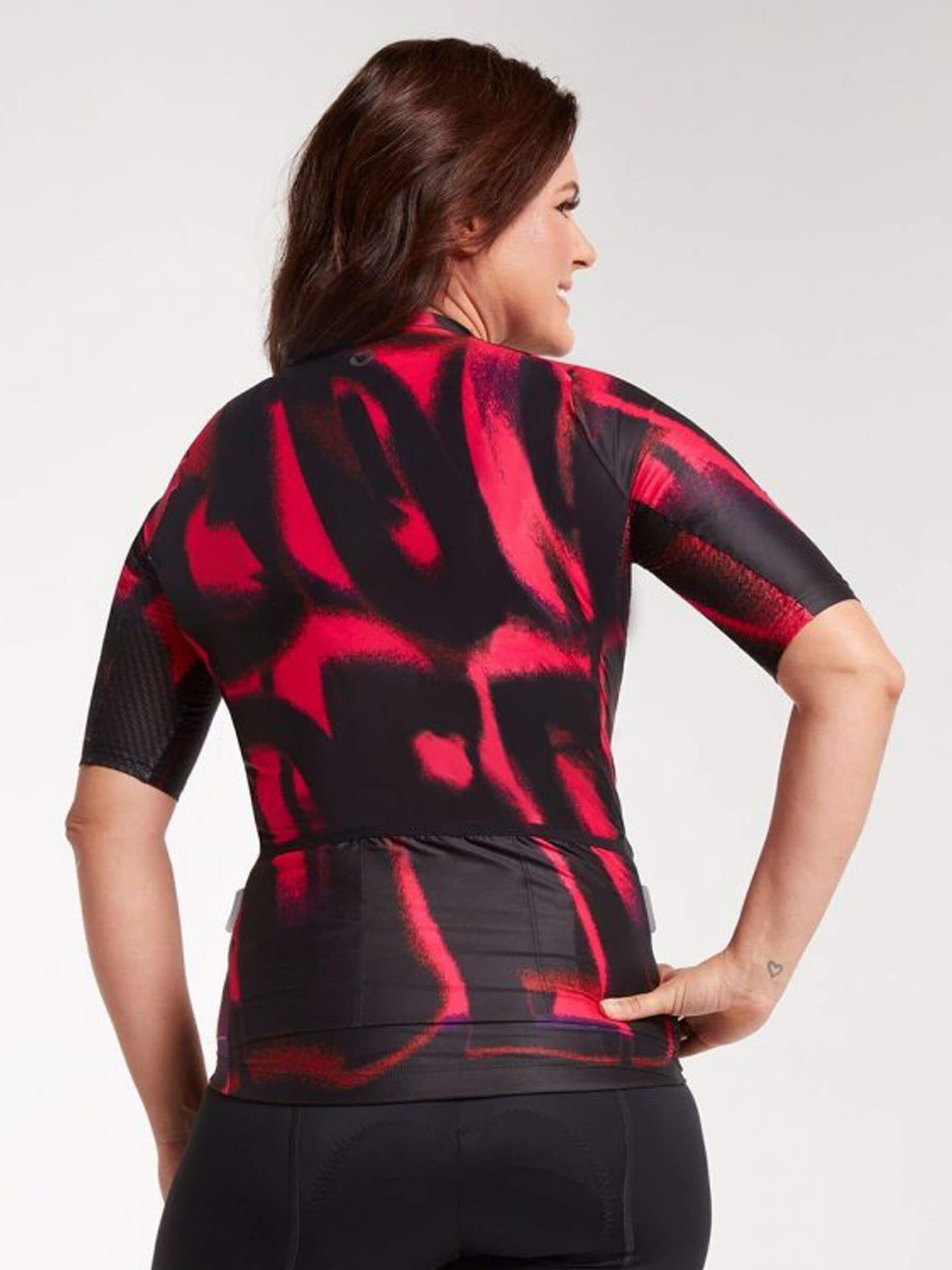Woman wearing Black and red women's cycling jersey with a print, made of lightweight and soft fabric for a perfect fit.