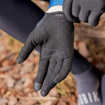 Cyclist's hands in GOBIK Lynx Gloves in black, showing the interaction with bike components.