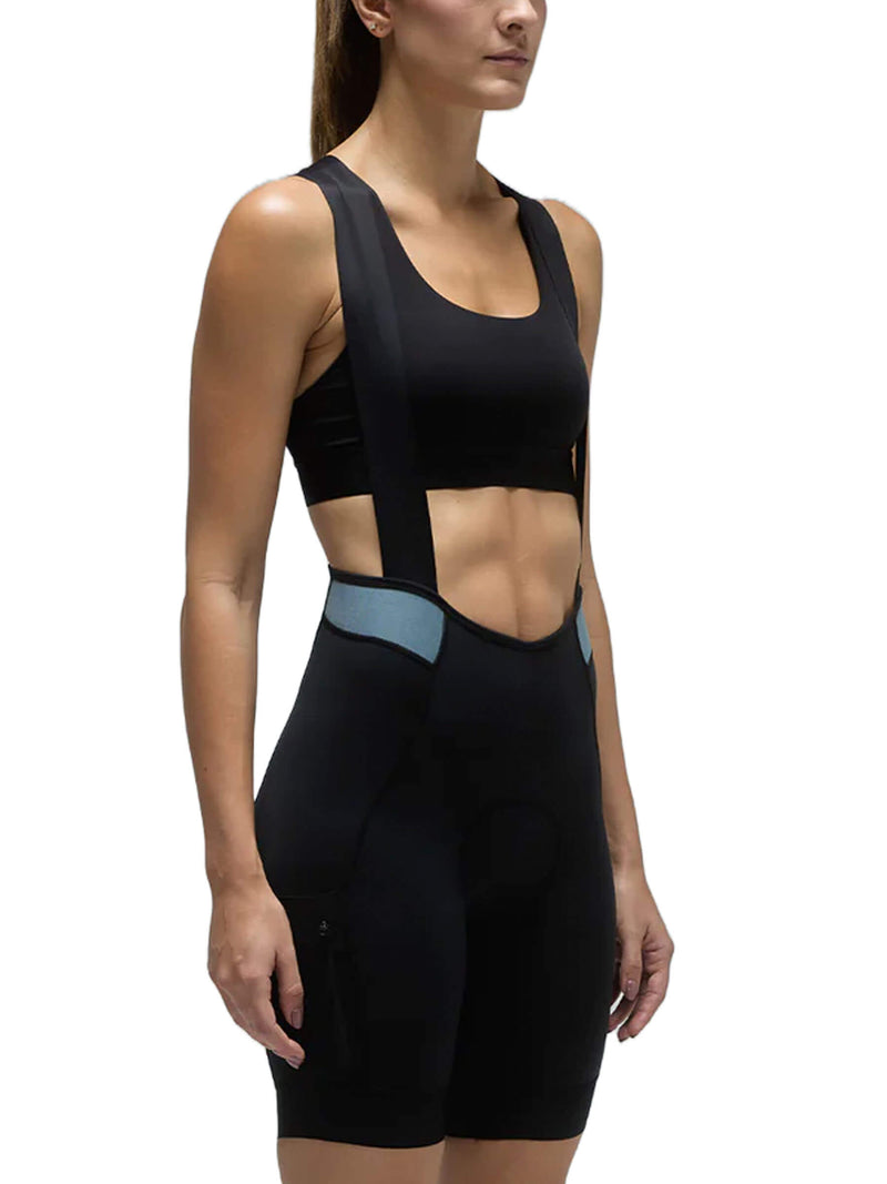 Woman in black Givelo MC Cargo Bib Shorts with blue accents, designed for cycling comfort.