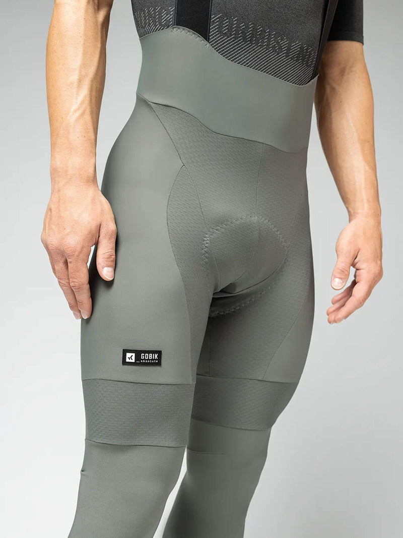 Adjusting GOBIK Evergreen Bib Tights: Close-up showing the fit and textured material of the tights on a male cyclist.