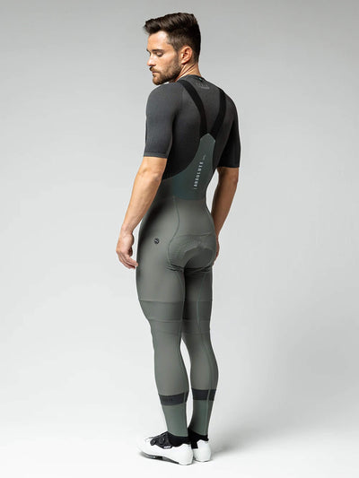 Adjusting GOBIK Evergreen Bib Tights: Close-up showing the fit and textured material of the tights on a male cyclist.