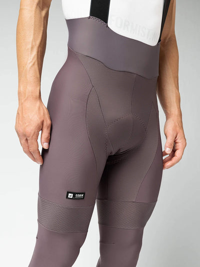 Men's GOBIK Absolute 6.0 Bib Tights in java: Full-length shot of a cyclist in java-colored tights and a white top, ready for a ride.