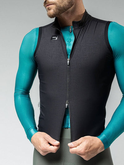 Close-up of male cyclist zipping up Gobik Men's Crow Vest, showcasing the convenience and fit of the double-slider zipper.