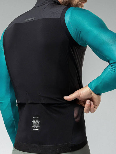 Back view of male cyclist in Gobik Men's Crow Vest, showing the siliconed piping and reflective details for visibility and fit.