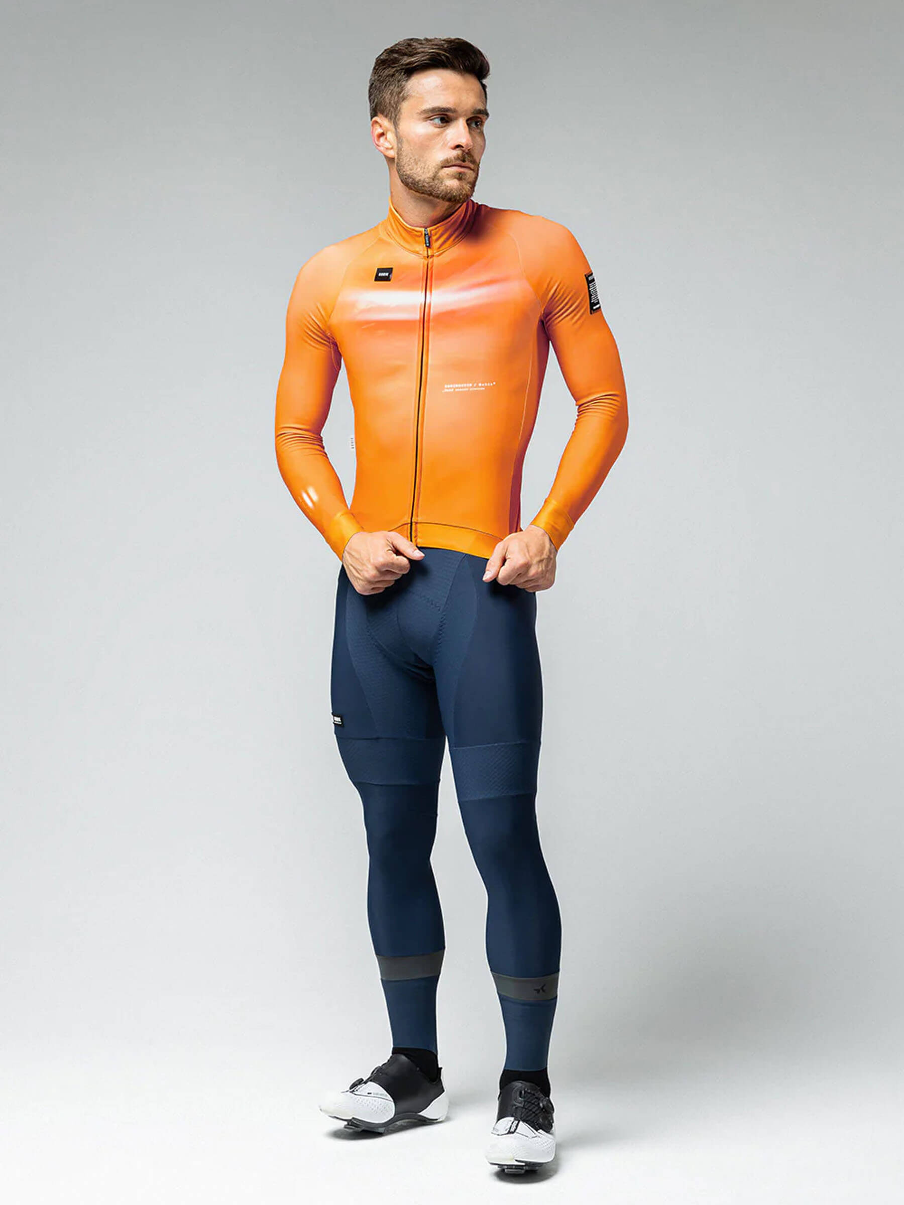 Man in GOBIK Hyder jersey featuring a cheddar hue with snug sleeves and a fitted silhouette for cold cycling.
