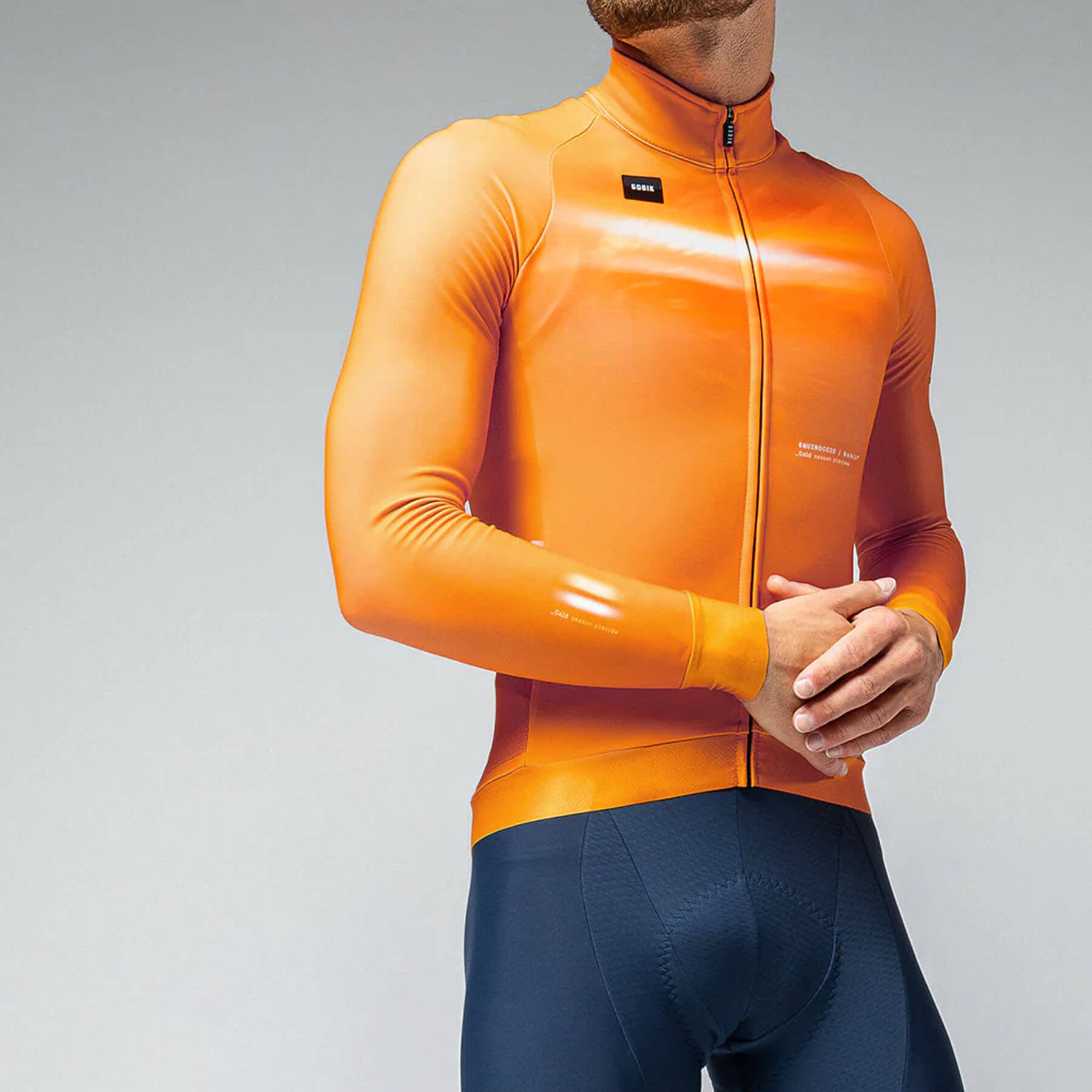 Man in GOBIK Hyder jersey featuring a cheddar hue with snug sleeves and a fitted silhouette for cold cycling.