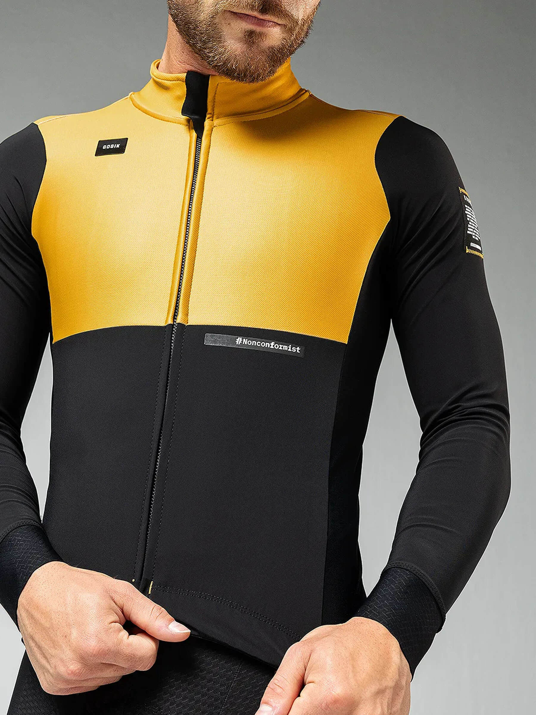 Close-up of man wearing GOBIK Mist Blend 2.0 Jacket - Men's in yellow and black with full zipper front detail