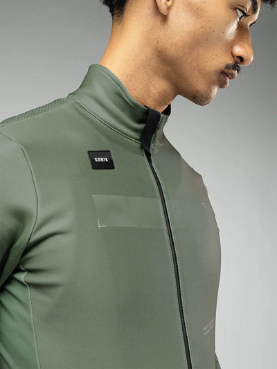 Close-up of GOBIK Skimo Pro jacket's collar and upper chest in hedge green, highlighting the water-resistant and windproof material.