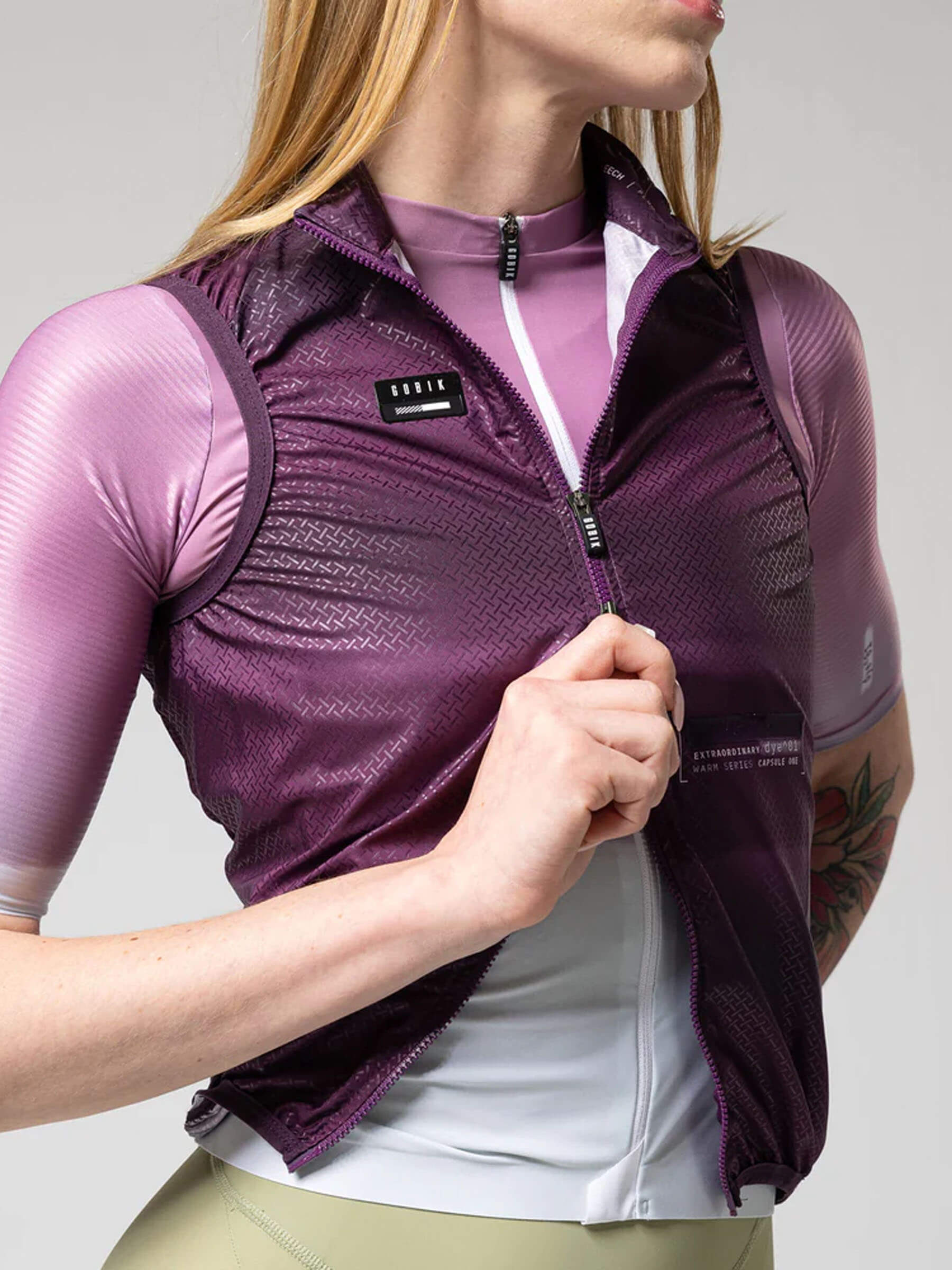 Close-up of a woman wearing the GOBIK Vest Plus 2.0 - Women's in purple with aerodynamics and fitted collar details
