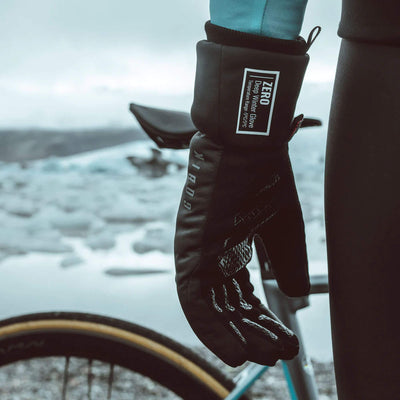 Primaloft Zero Thermal Gloves by GOBIK, hanging from a bike, showcasing their utility in cold weather.