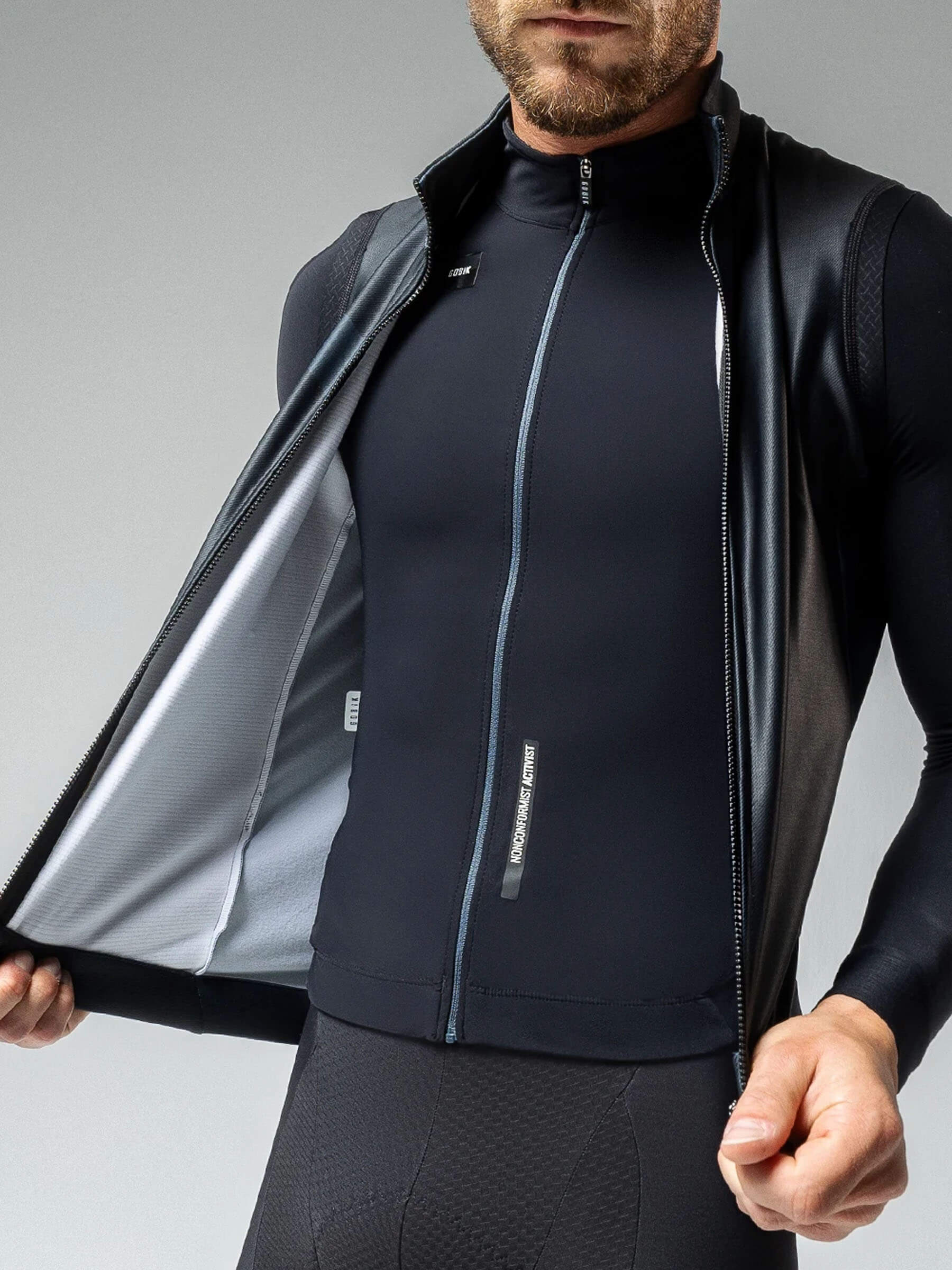 Man wearing GOBIK Thermal XMAX Gilet - Unisex showing its insulating inner lining for cold weather protection