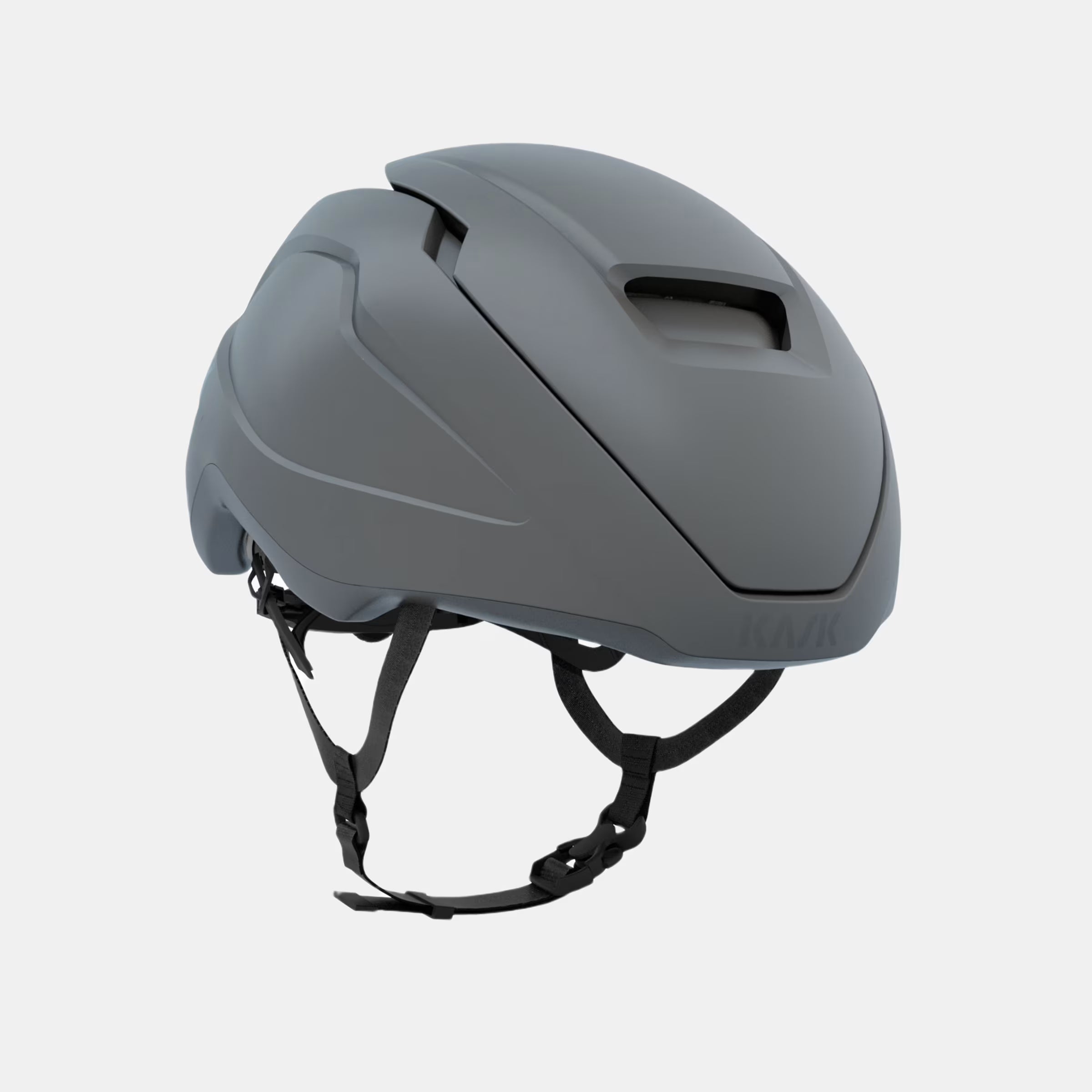 Kask Wasabi Helmet - Grey Matt shown at an angle highlighting sleek aerodynamic design and adjustable strap system