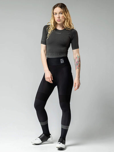 Caucasian woman models Gobik Absolute 6.0 Strapless Cycling Tights with neoprene waist, reflectors on legs, for 0-15°C weather.