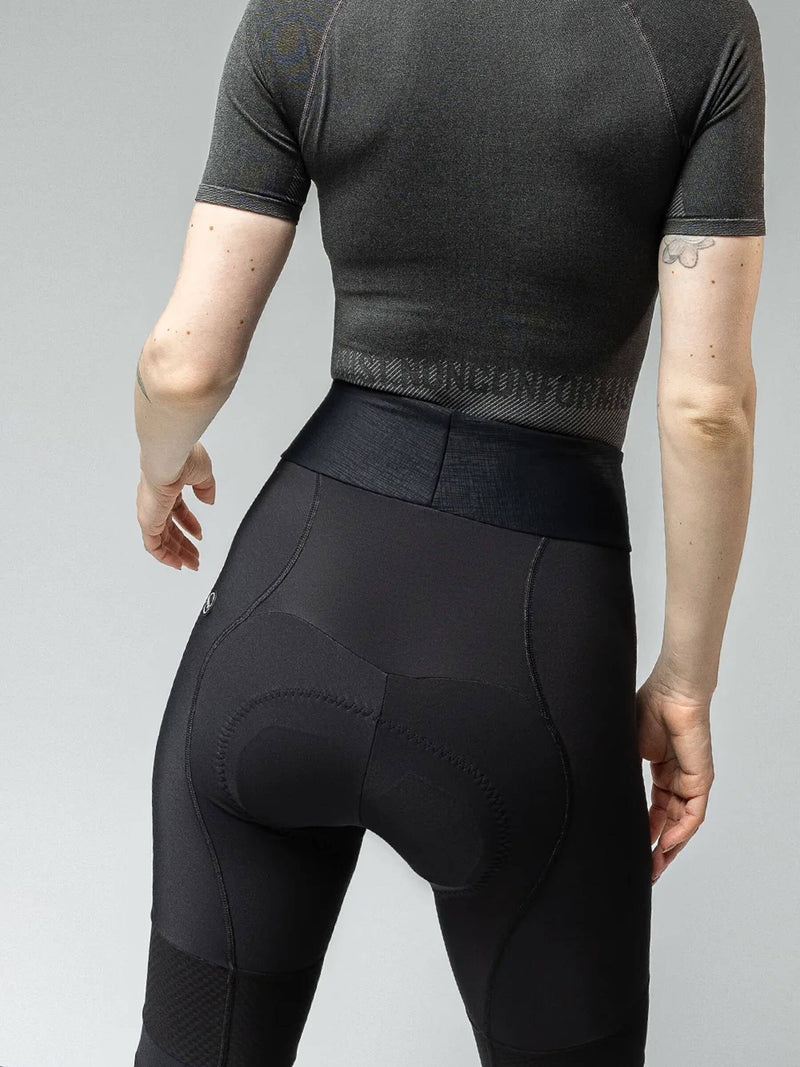 Woman in Gobik Absolute 6.0 Strapless Cycling Tights featuring high-waist design and textured patterns for visibility and comfort.