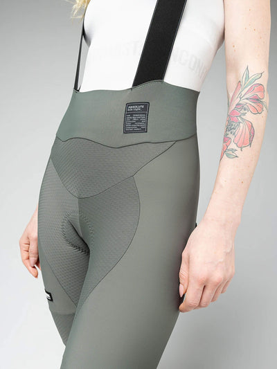 Close-up of GOBIK Absolute 6.0 K9 Women's Bib Tights: Detail shows the textured fabric and padding, with a label on the back and a tattooed arm on the side.