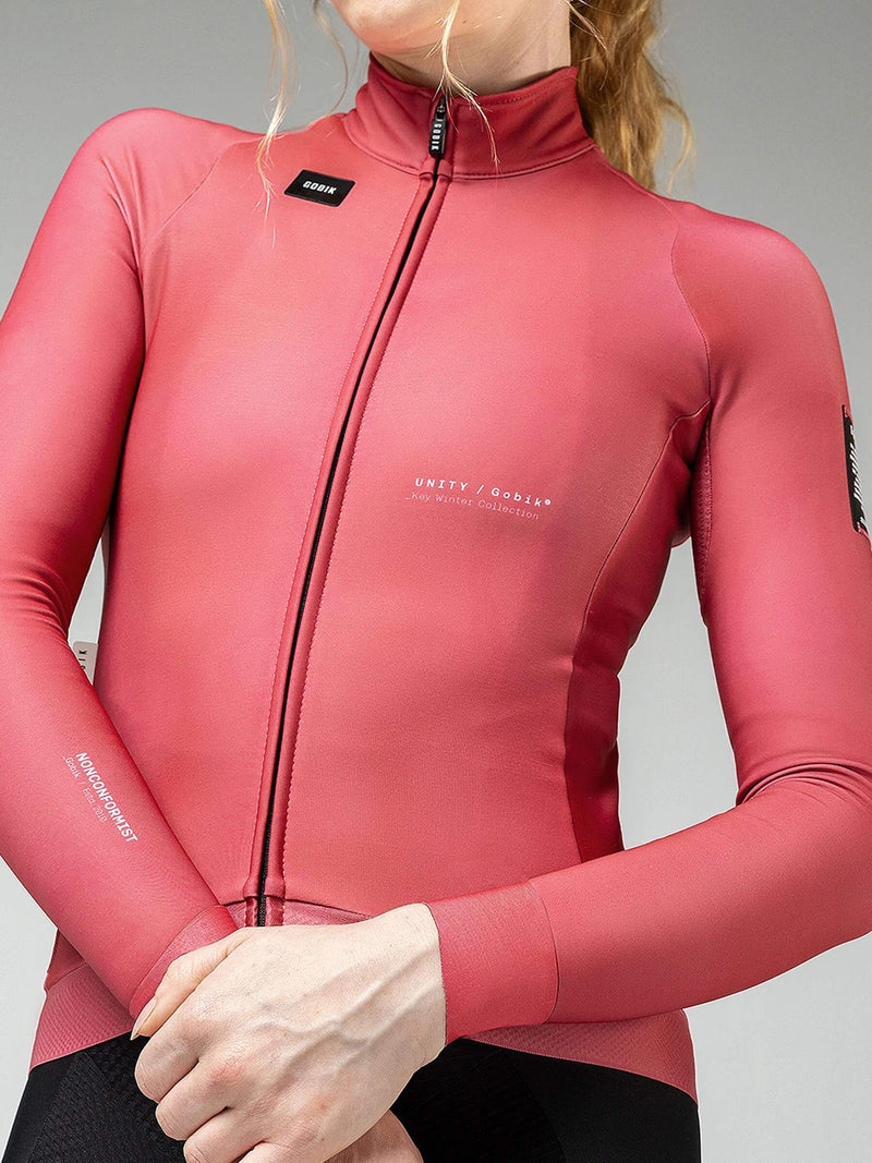Front view of a woman in an amaranth red Hyder jacket, featuring streamlined design for comfort and aerodynamics.