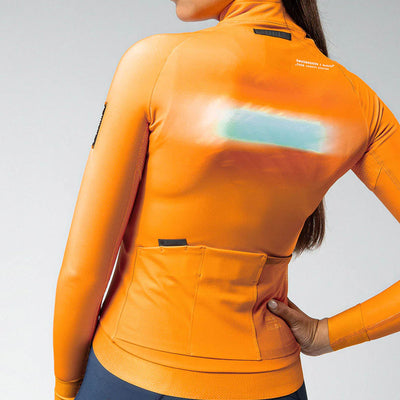 Rear view of madras orange Hyder jacket showing dual back pockets with GRS system and additional side mesh pocket.