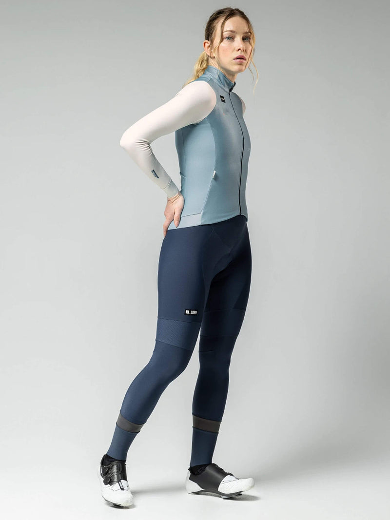 Female cyclist in Superhyder jersey, side view showing streamlined design with flexible sleeves, for variable weather cycling.