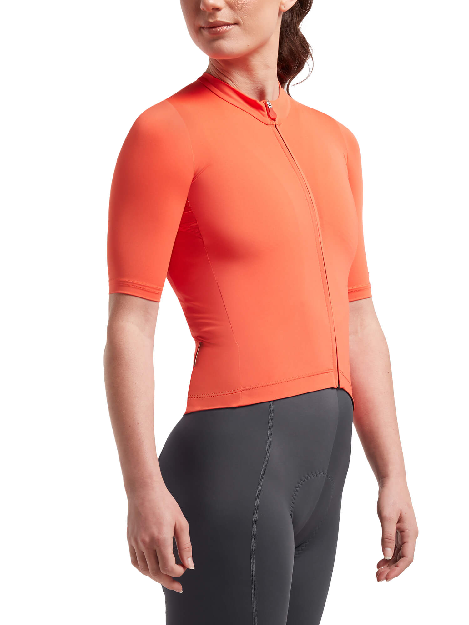 Woman wearing Black Sheep Cycling Essentials TEAM Jersey SS22- Women's in bright coral with fitted sleeves and front zipper
